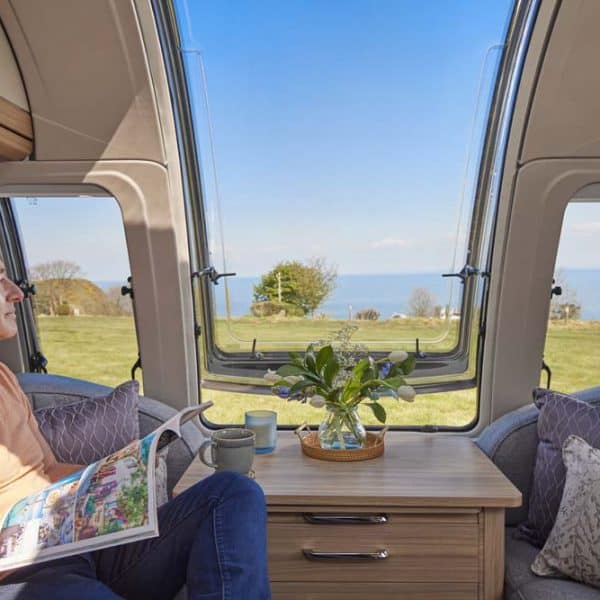 inside the Unicorn Series 5 with a man enjoying the stunning ocean view from the Bailey infinity window